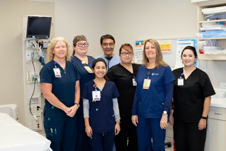 This is a picture of seven employees in a emergency room